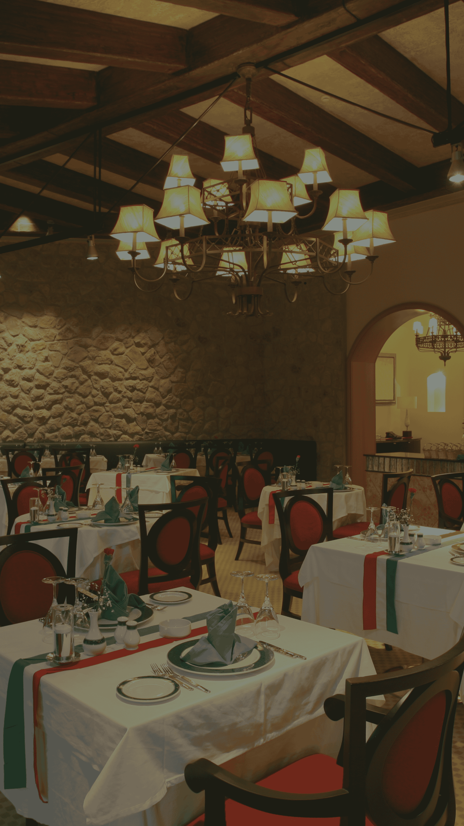 The background shows the interior of Third Eye Restaurant, featuring a dining space with a high wooden beam ceiling and a large chandelier with multiple lamp shades. The dining area has neatly arranged tables with white tablecloths and formal place settings. A wine rack is visible along the wall at Third Eye Windsor, 515 George St, South Windsor NSW 2756.